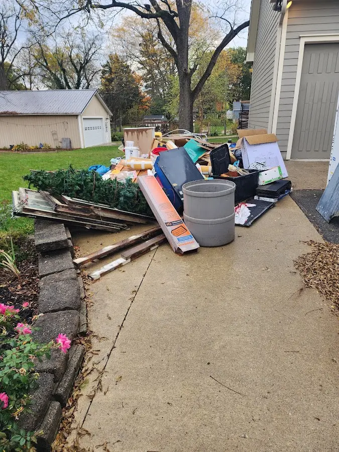 Dumpster being loaded with debris for Residential Dumpster Rental in Pearsall